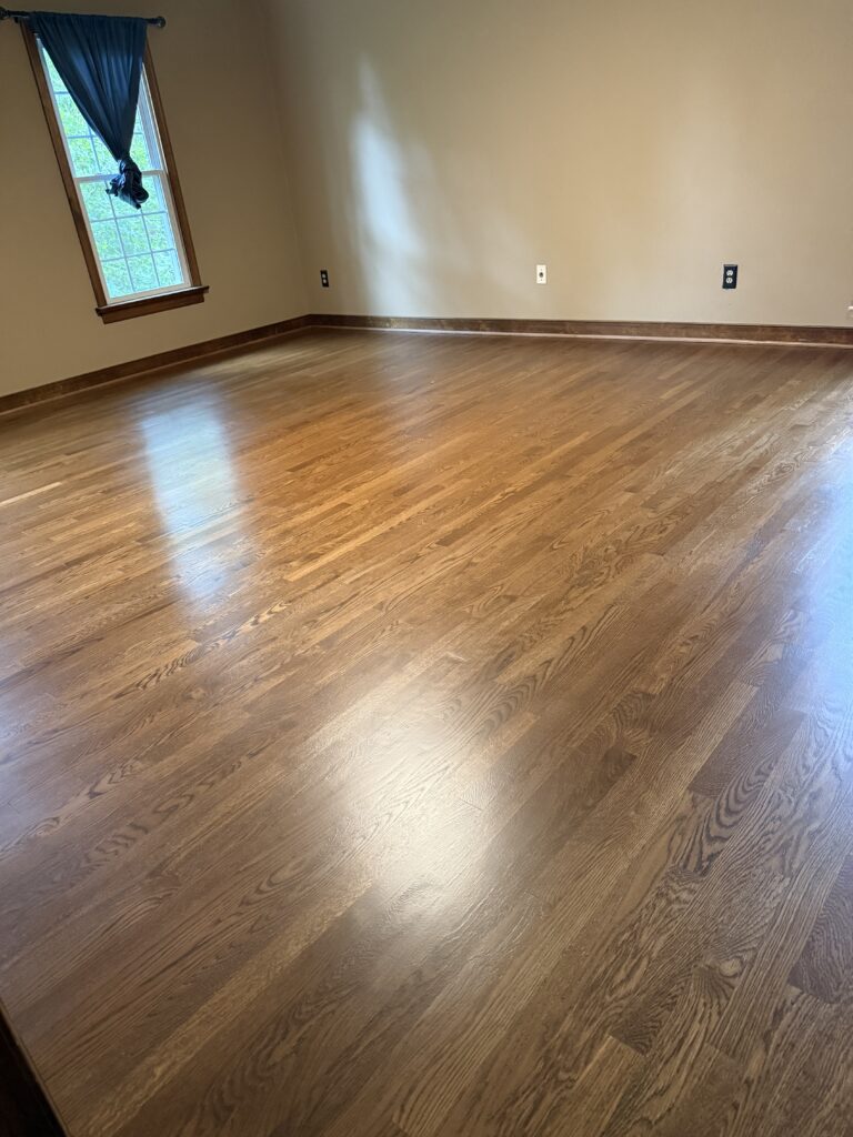 Empty room with polished wooden floor.