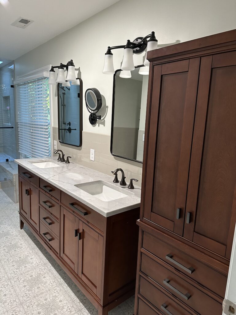 Modern bathroom with double vanity and cabinets.