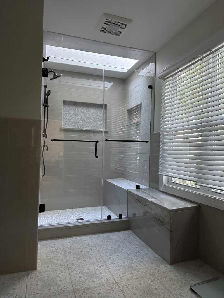 Modern bathroom with glass shower enclosure.