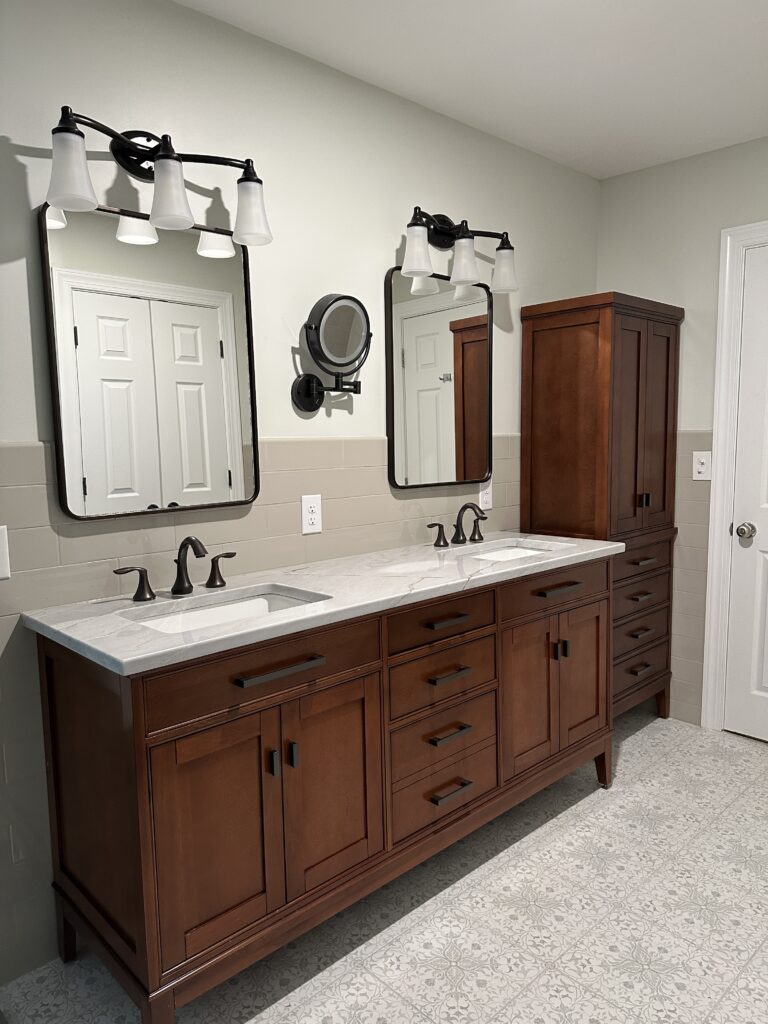 Double vanity bathroom with wooden cabinets.