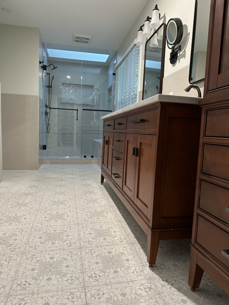 Modern bathroom with wooden vanity and shower.