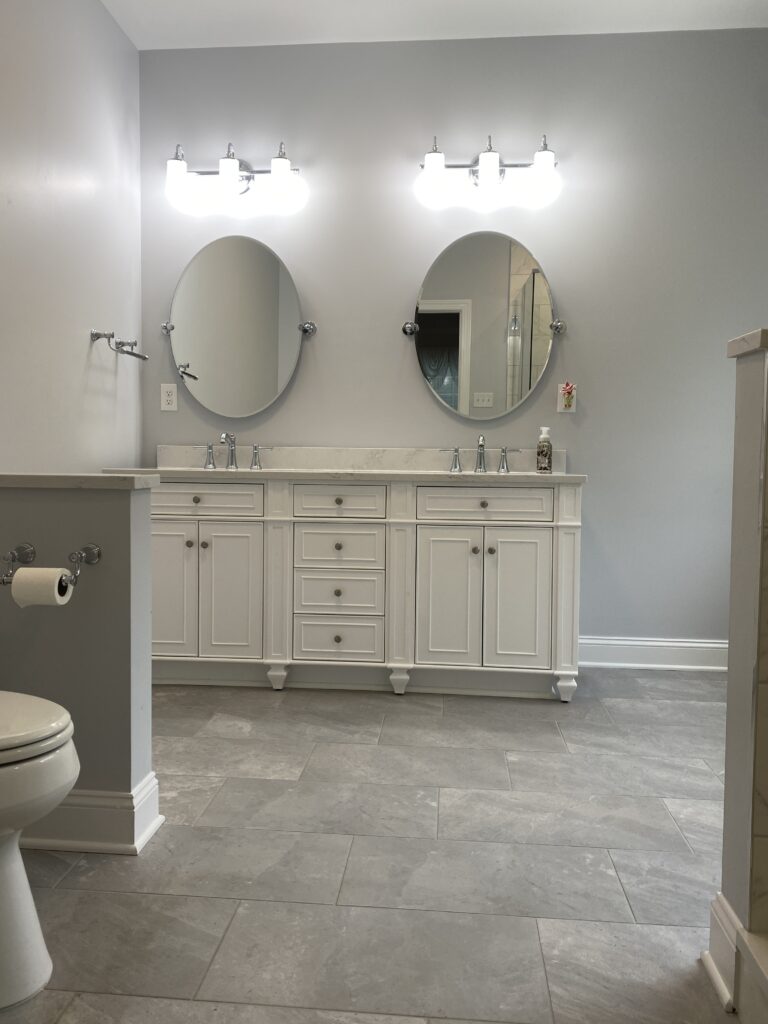 Modern bathroom with double vanity and mirrors.