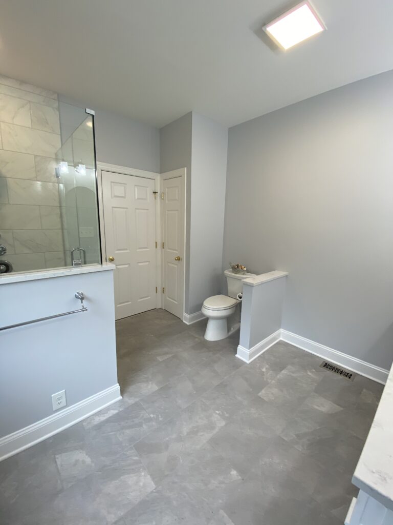 Modern bathroom with shower and toilet.