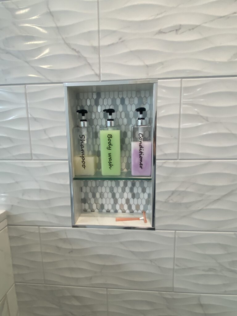 Shower niche with shampoo, body wash, conditioner.
