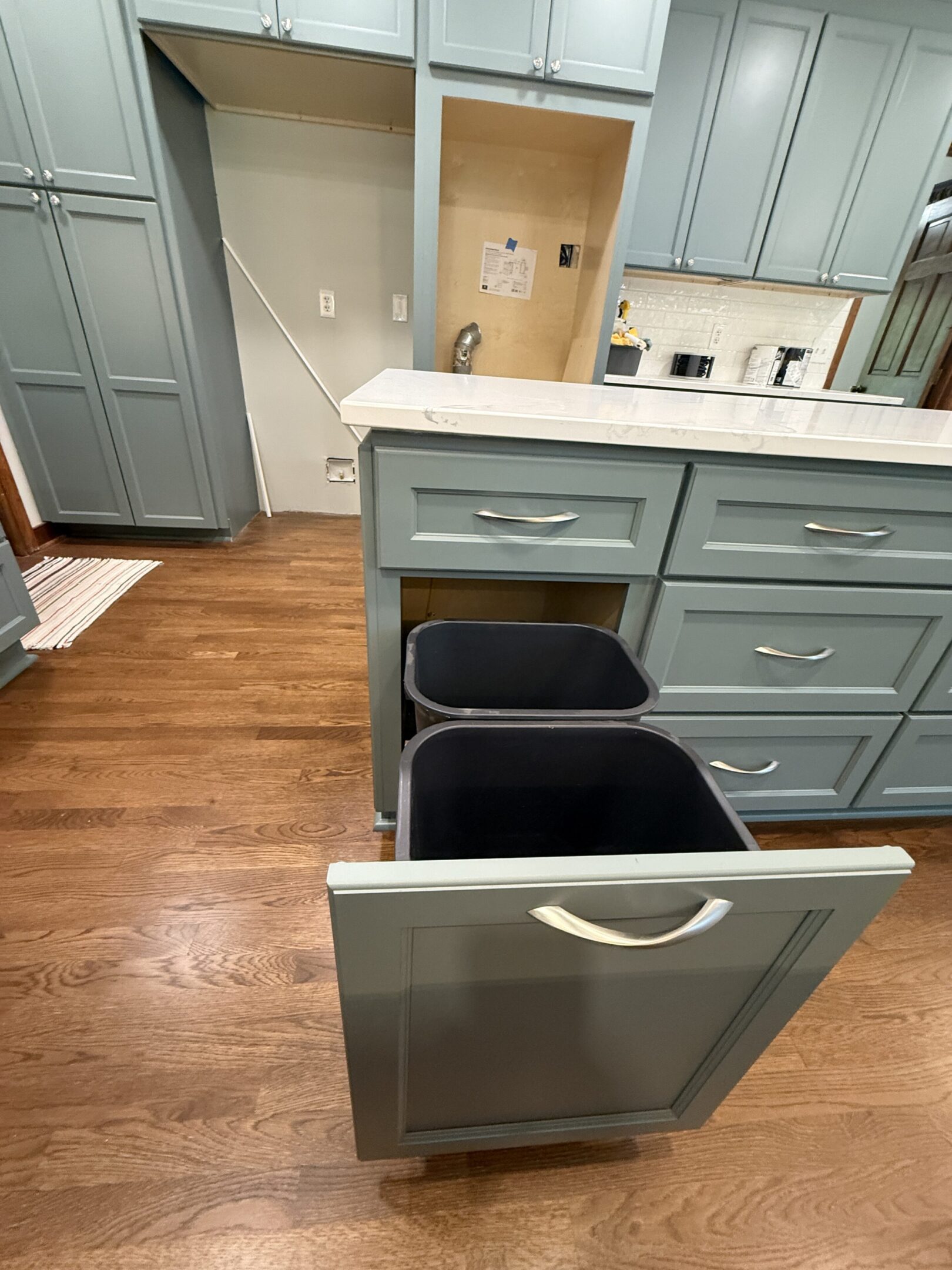 Pull-out trash bins in modern kitchen.
