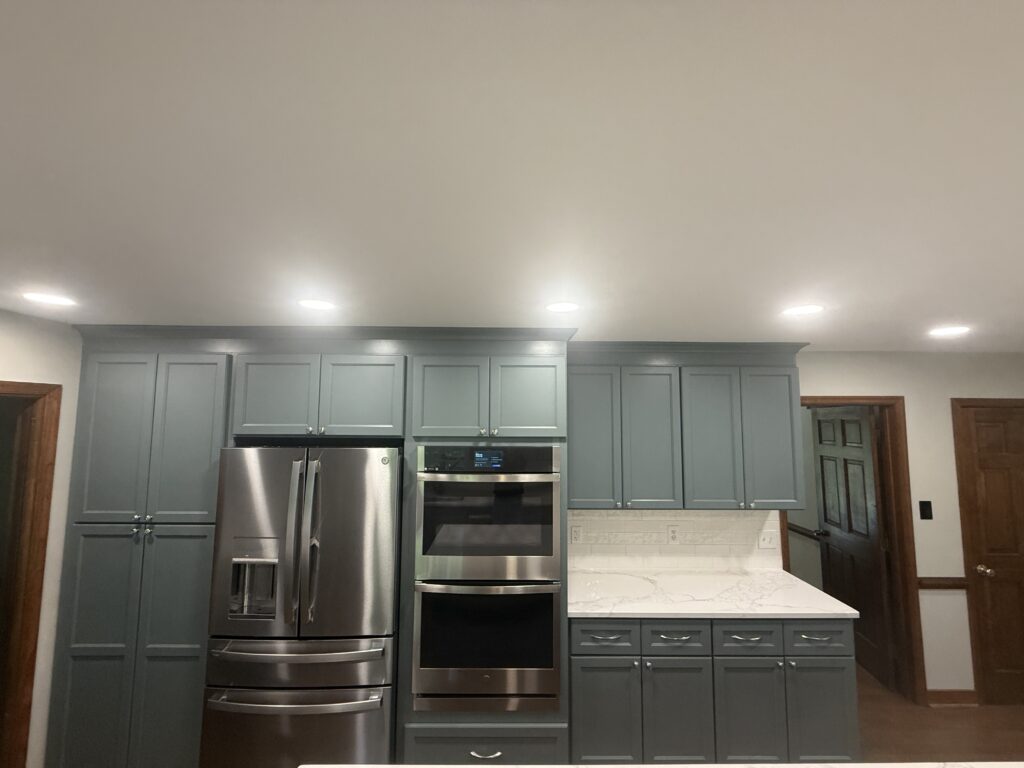 Modern kitchen with gray cabinets and appliances.