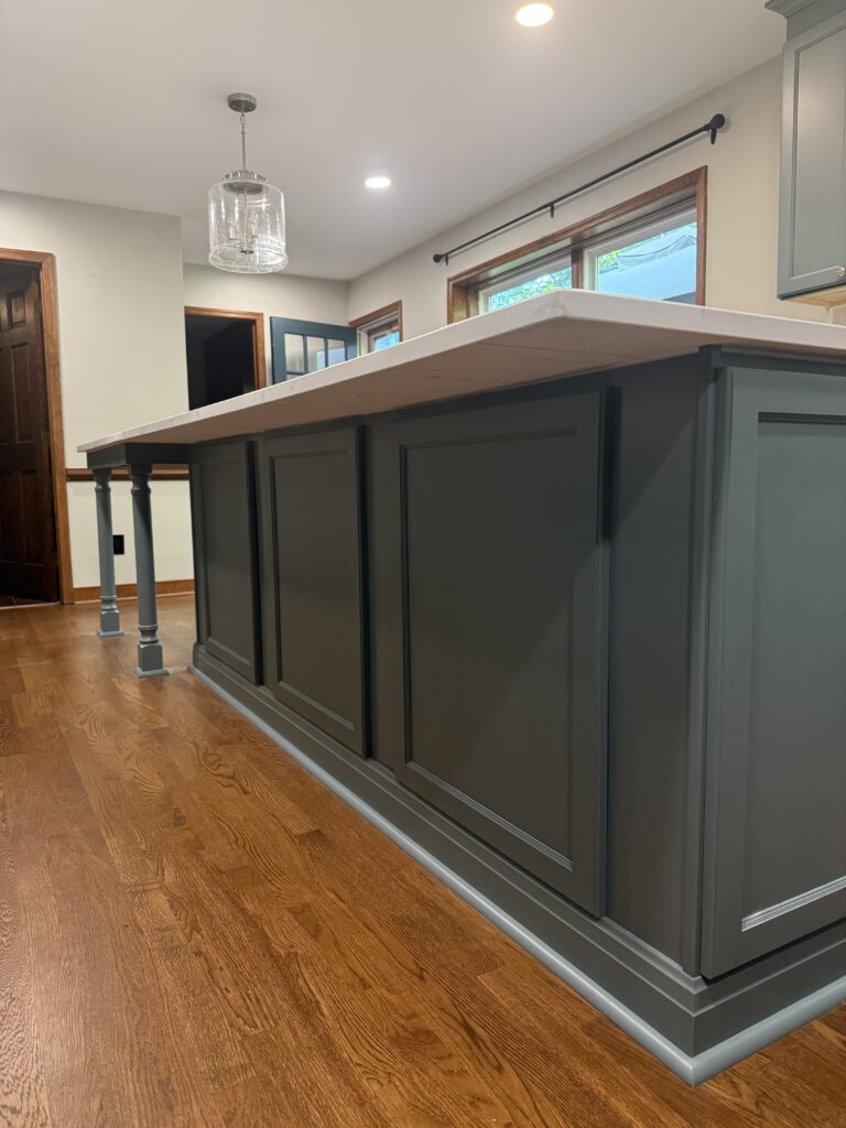 Modern kitchen island with wooden flooring.