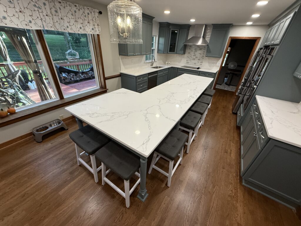 Modern kitchen with large island and stools.