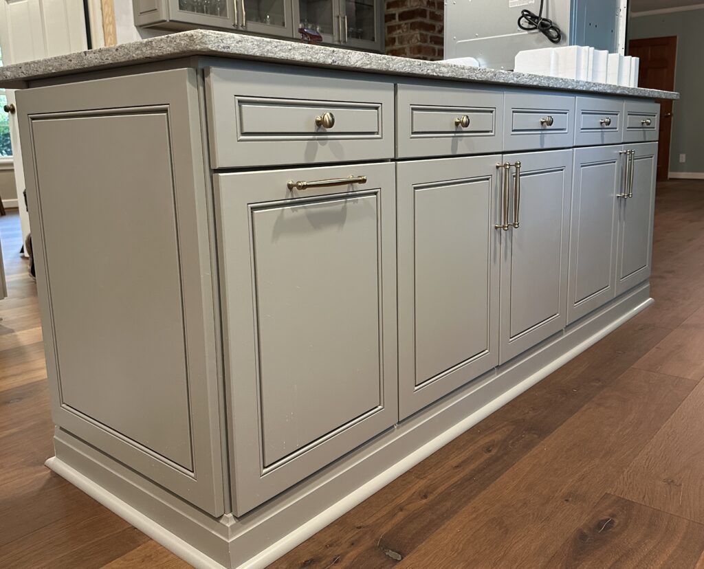 Gray kitchen island with granite countertop.