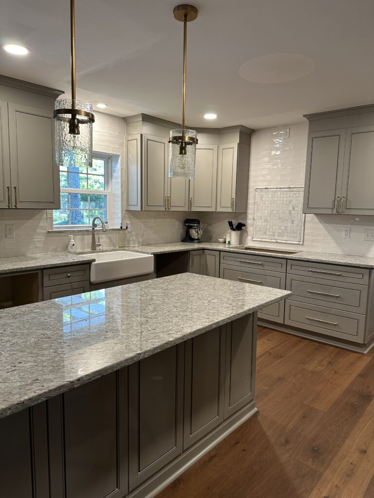 Modern kitchen with gray cabinets and island.