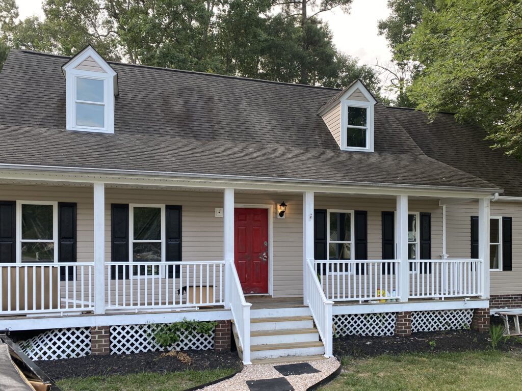 House with red door and white porch.