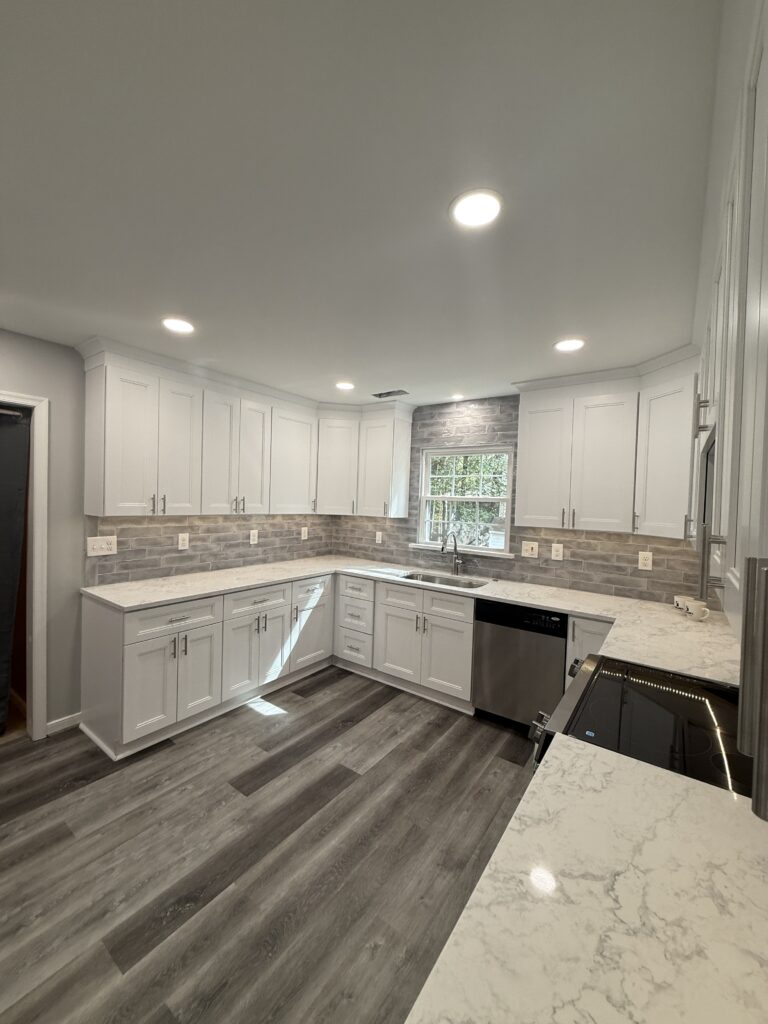 Modern kitchen with white cabinets and countertops.
