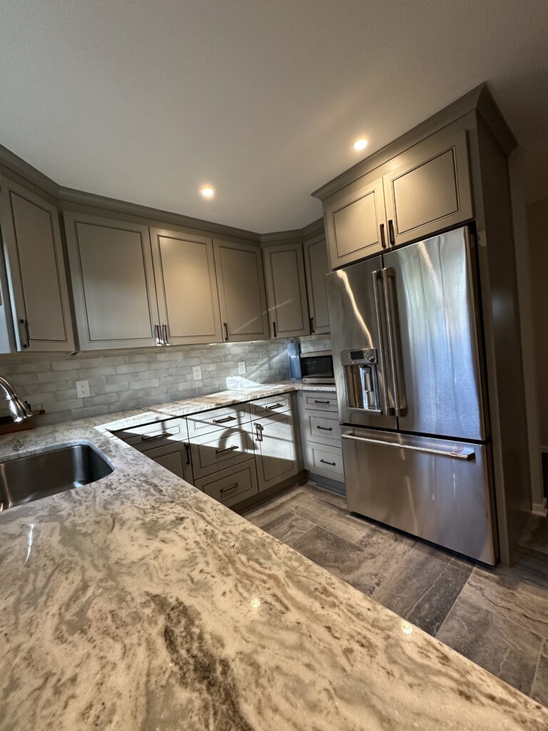 Modern kitchen with granite countertops and cabinets.