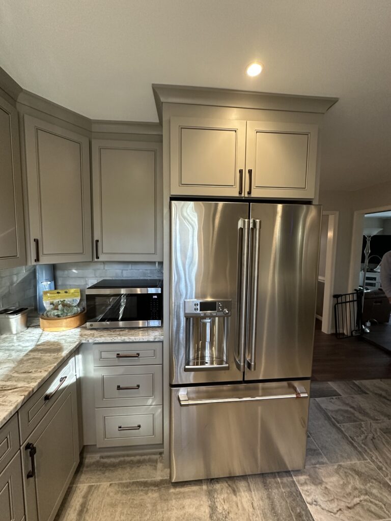 Modern kitchen with stainless steel refrigerator.