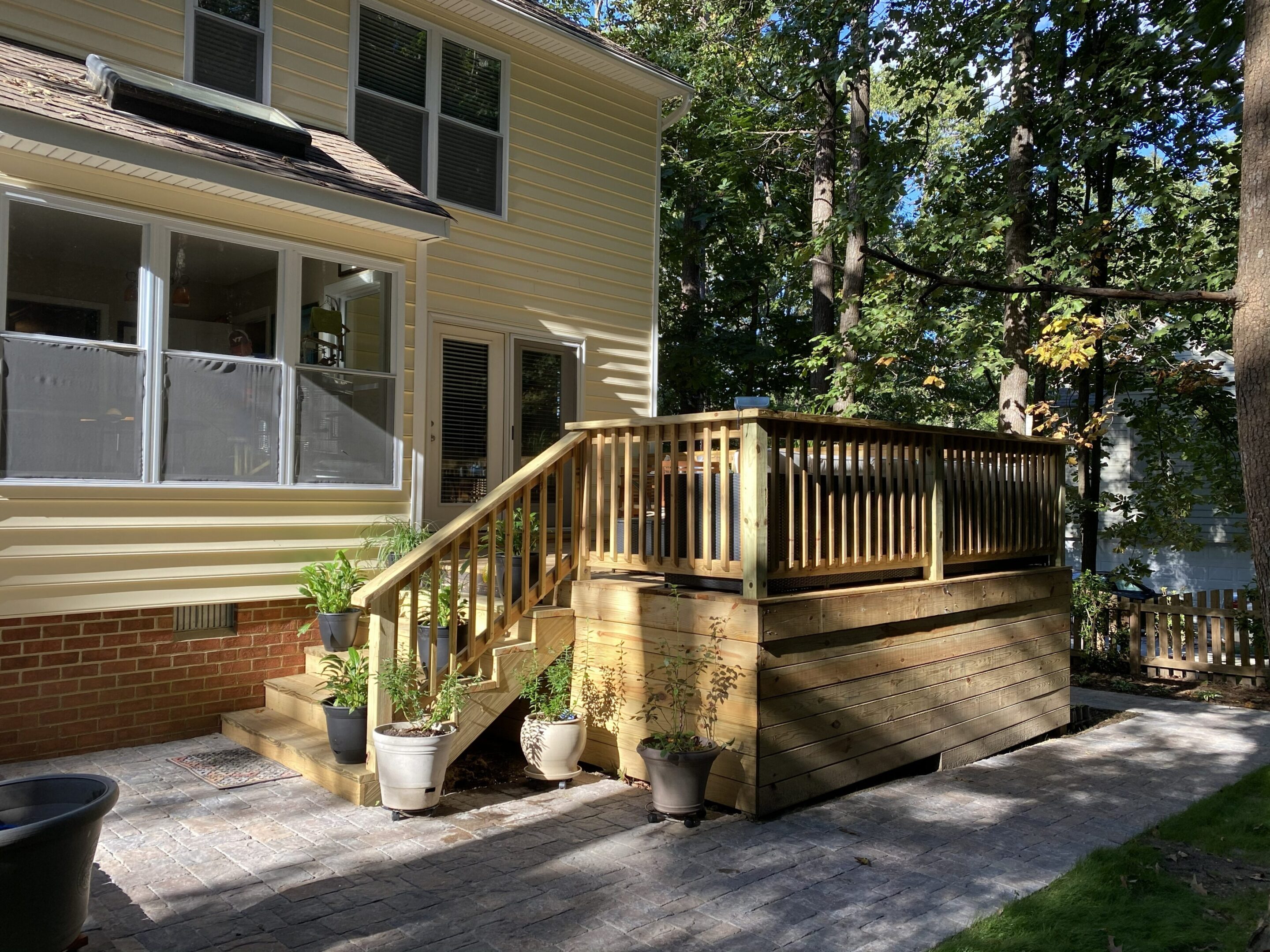 Deck railing overlooking wooded backyard