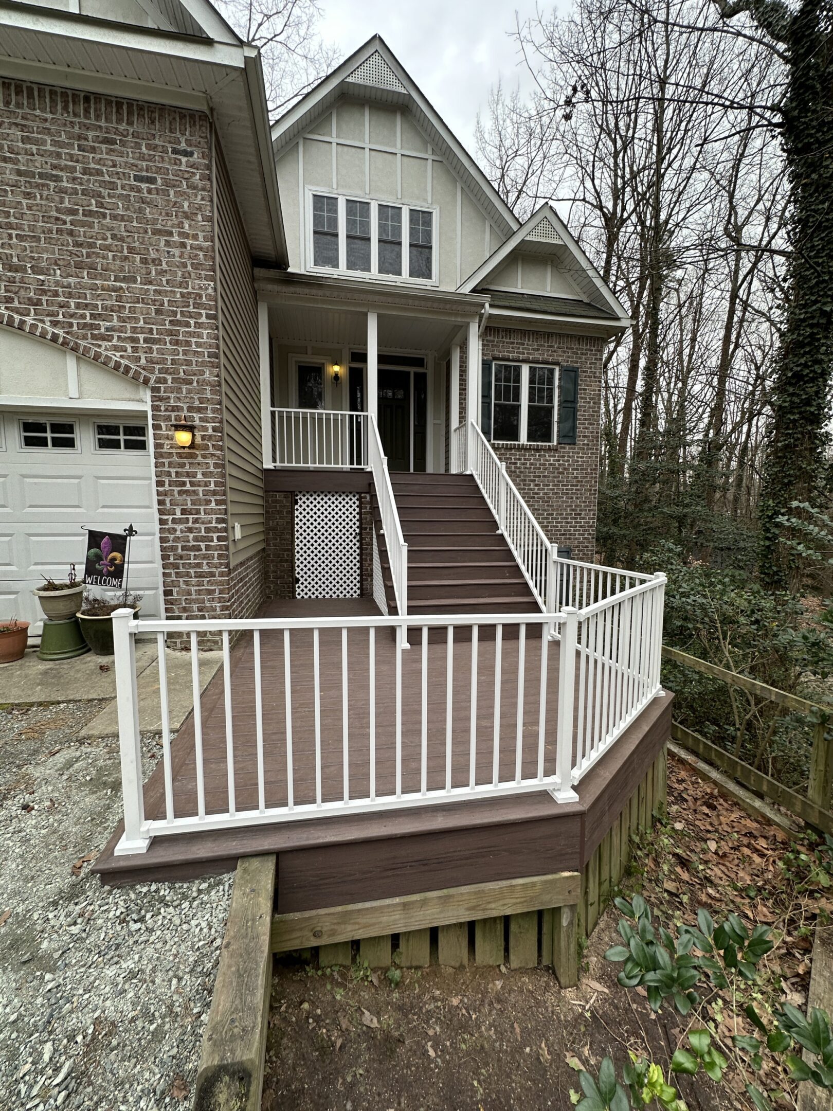 House with ramp and white railing entrance.