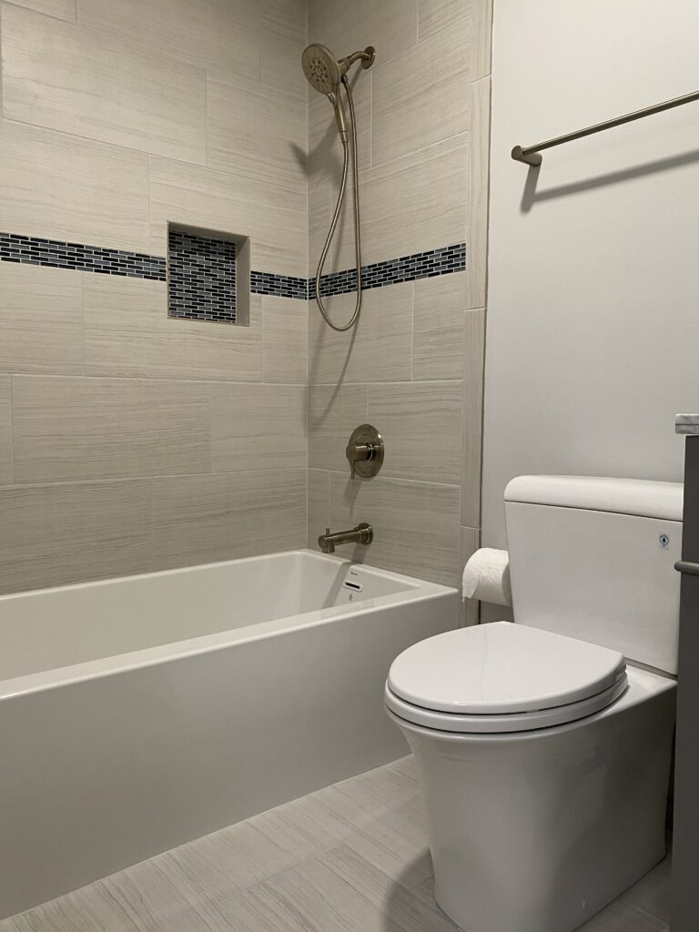 Modern bathroom with bathtub and toilet.