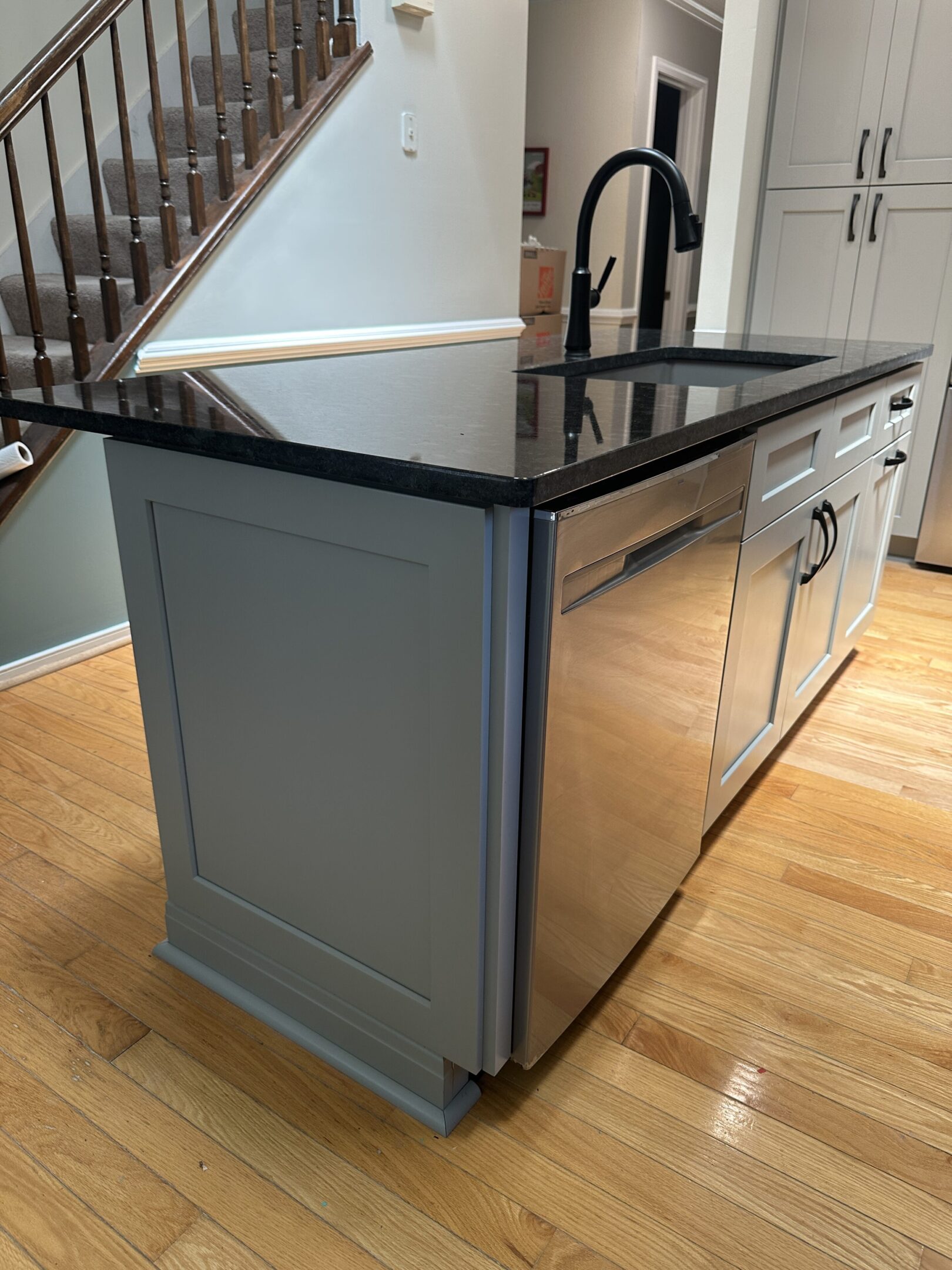 Black granite island with matte black faucet