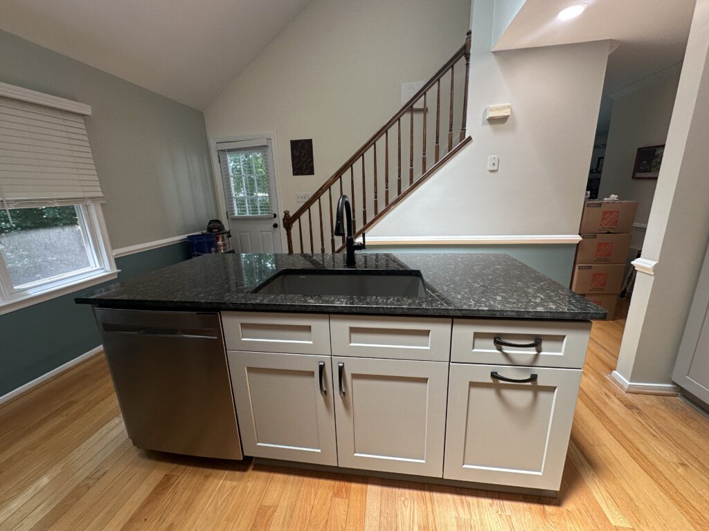 Modern kitchen island with granite countertop.