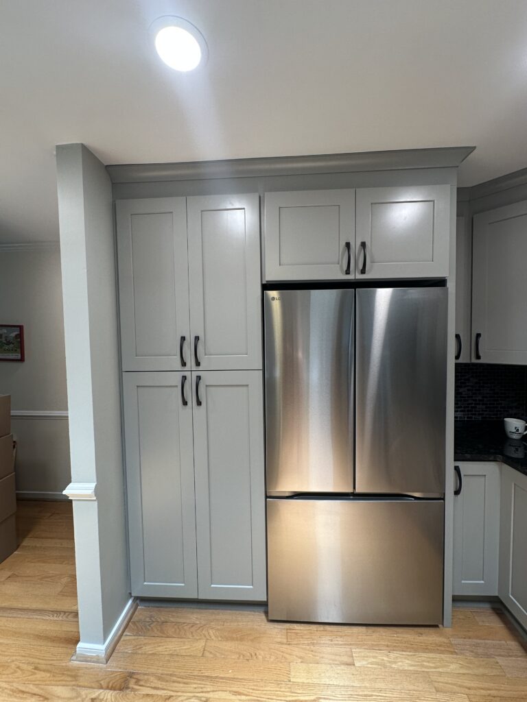 Modern kitchen with stainless steel refrigerator.