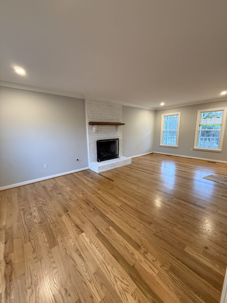 Spacious living room with wooden flooring.