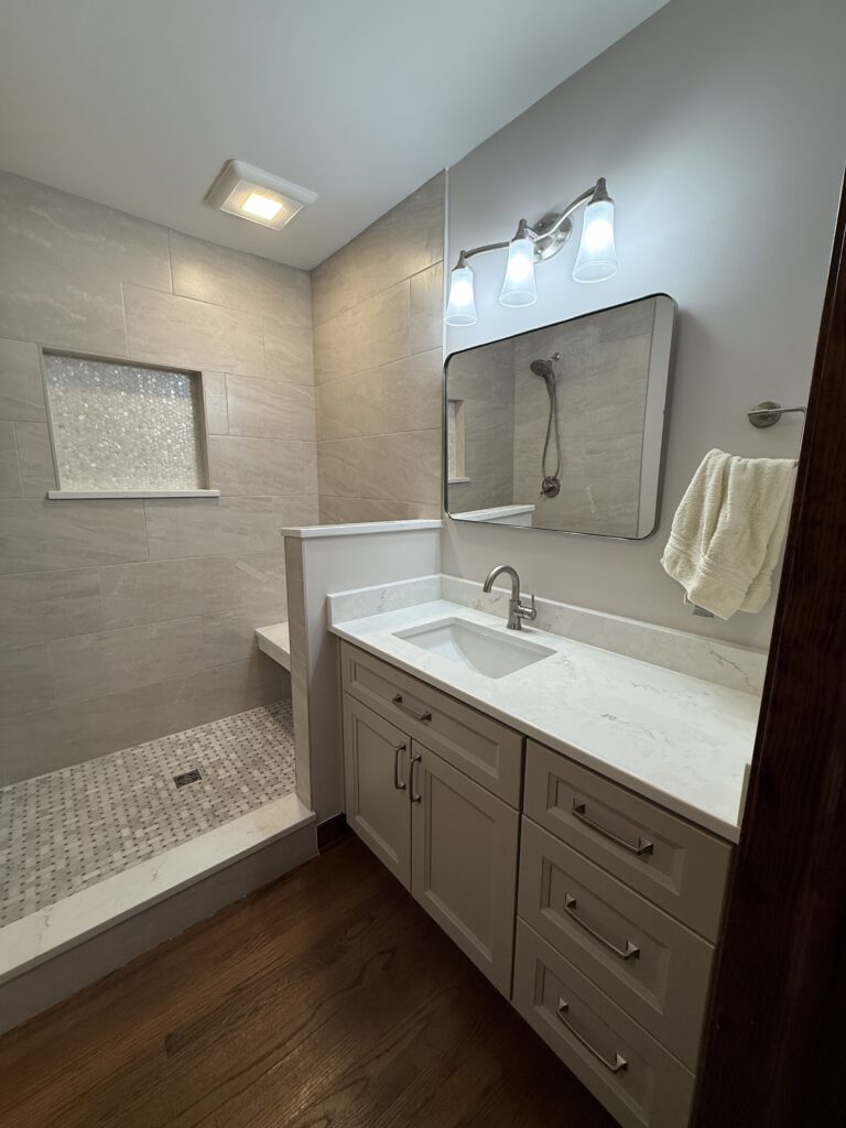 Modern bathroom with shower and vanity unit.