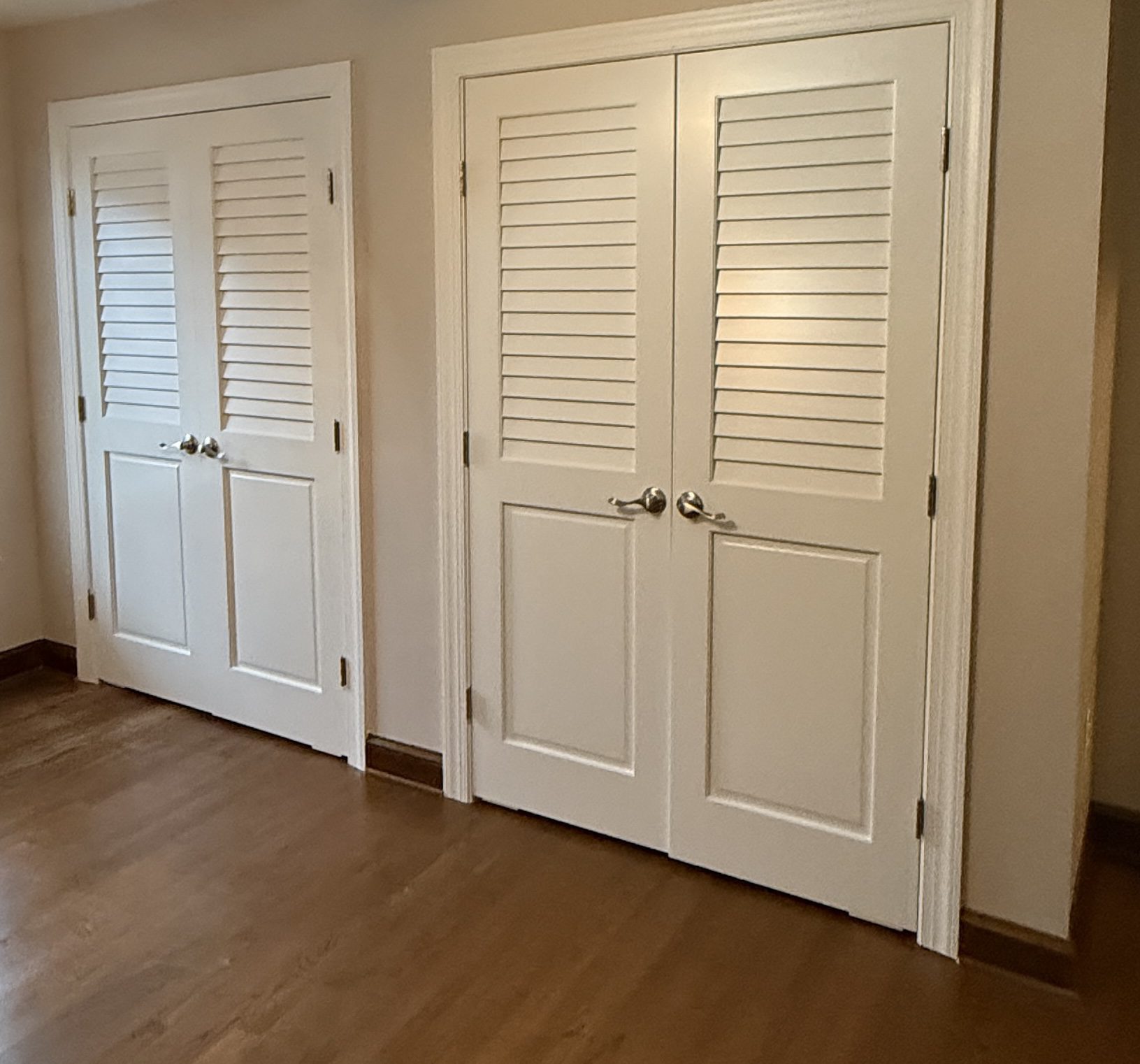 White double doors in a room corner.