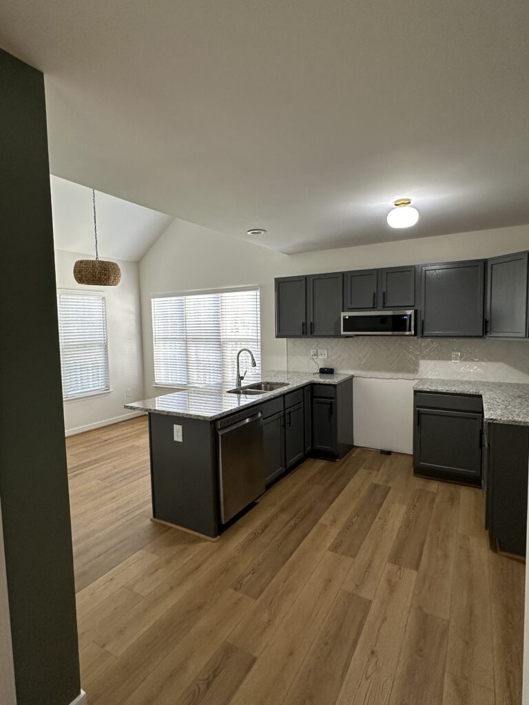 Modern kitchen with dark cabinets and island.