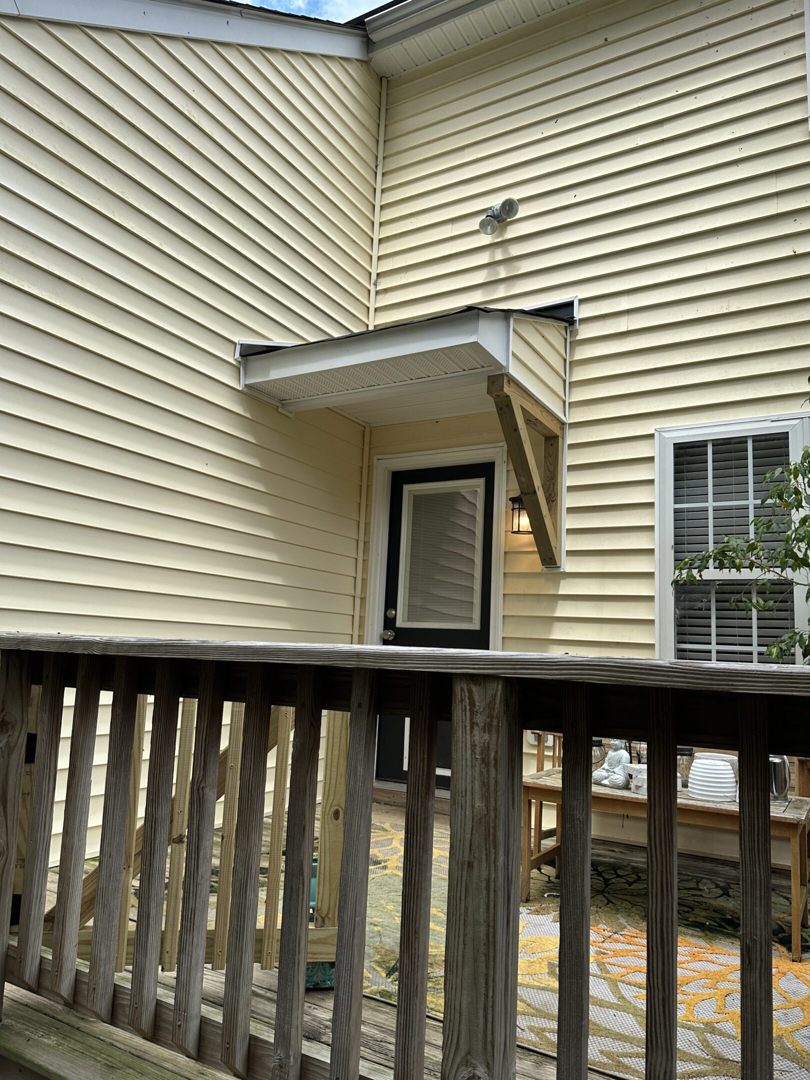 House exterior with porch and railing.