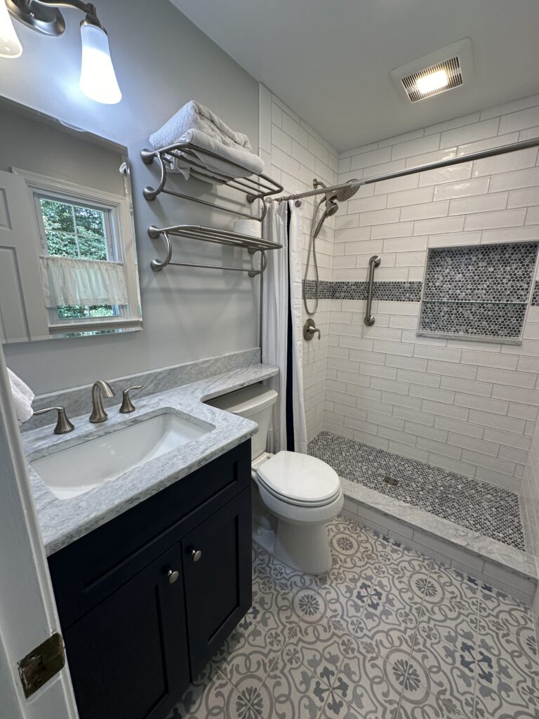 Modern bathroom with shower and patterned tiles.