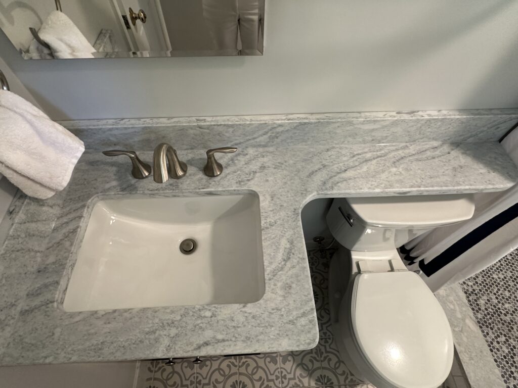 Bathroom vanity with sink and toilet.