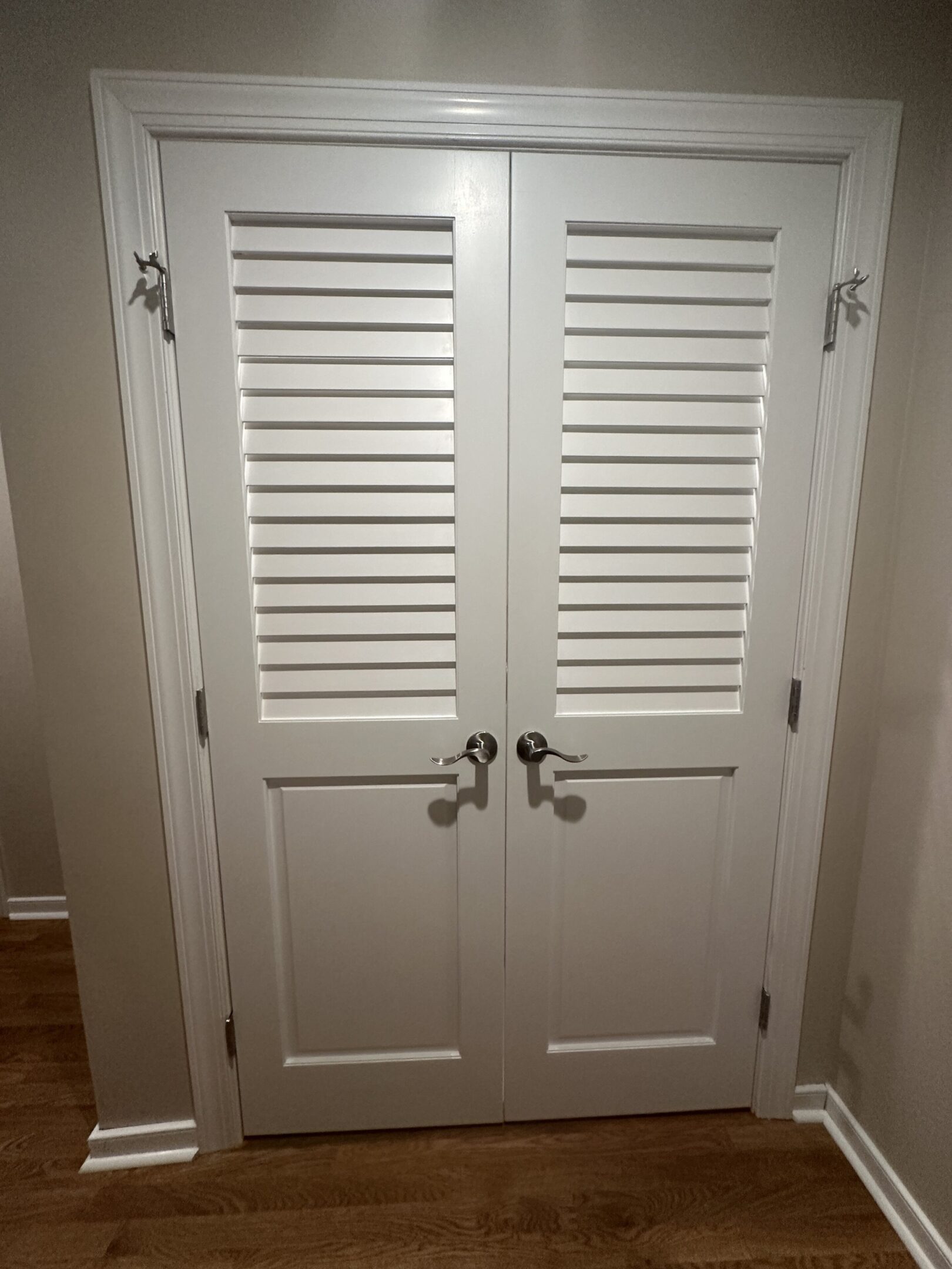 White louvered double doors in hallway.