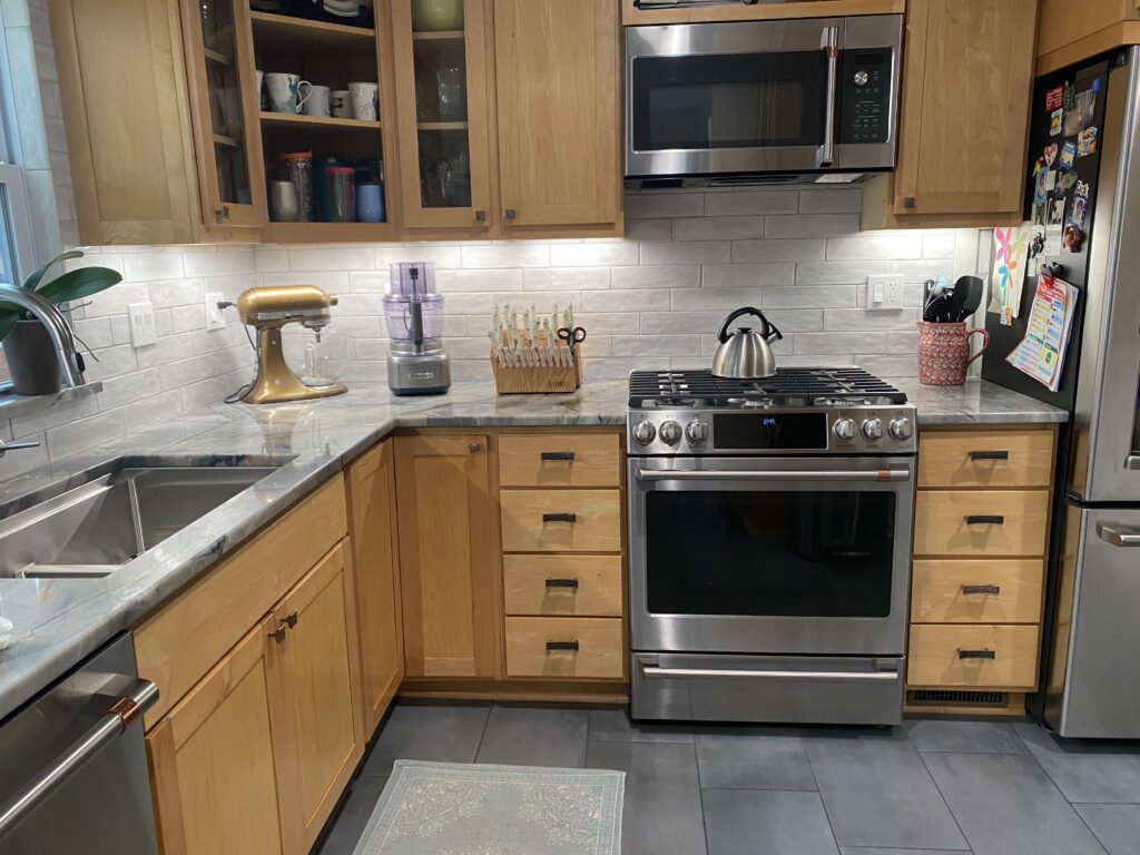 Modern kitchen with wooden cabinets and appliances.