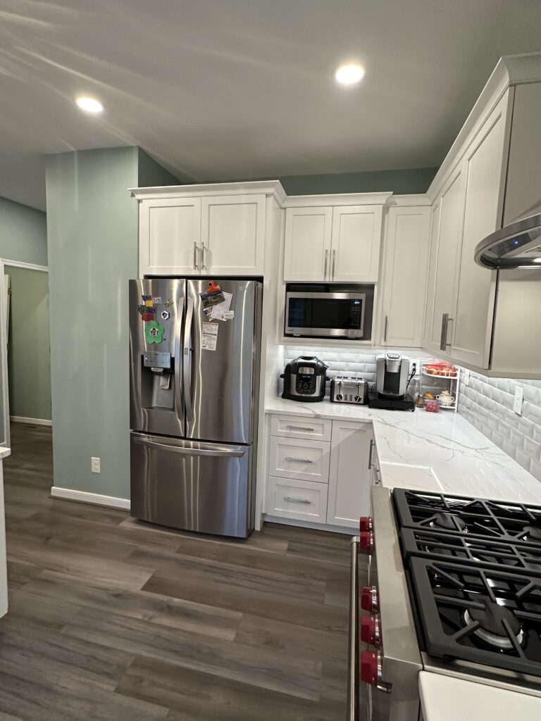 Modern kitchen with stainless steel appliances.