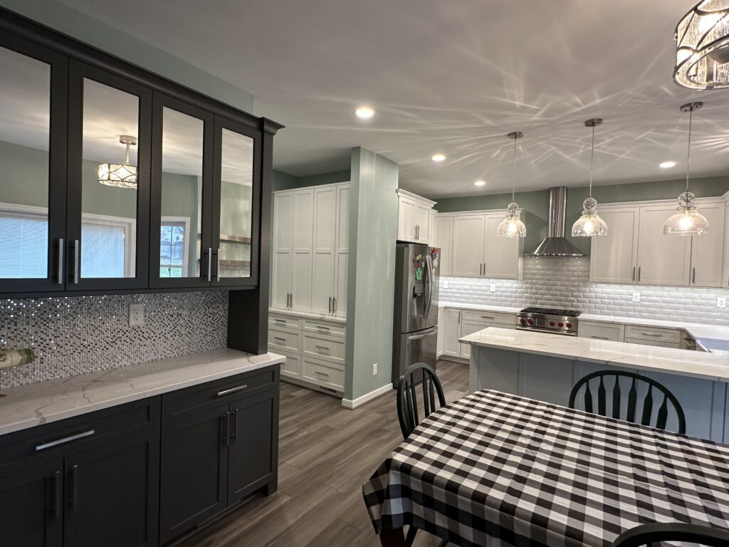 Modern kitchen with checkered tablecloth and cabinets.