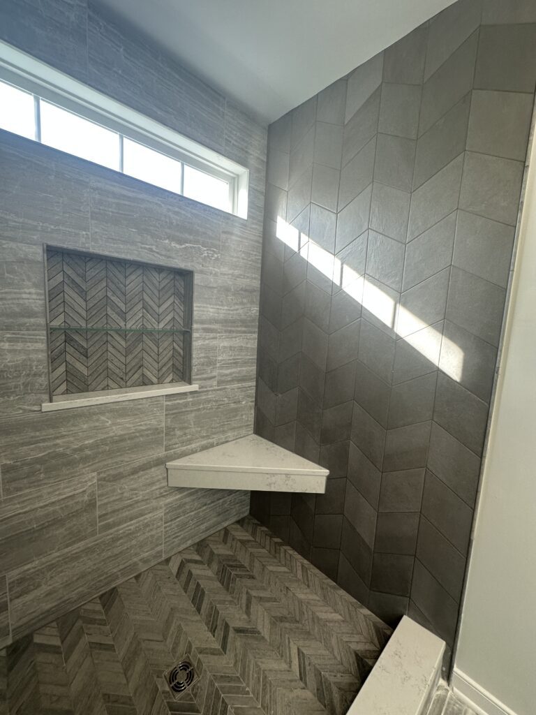 Modern shower with chevron tile design.