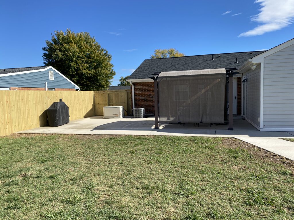 Backyard with patio and pergola structure.
