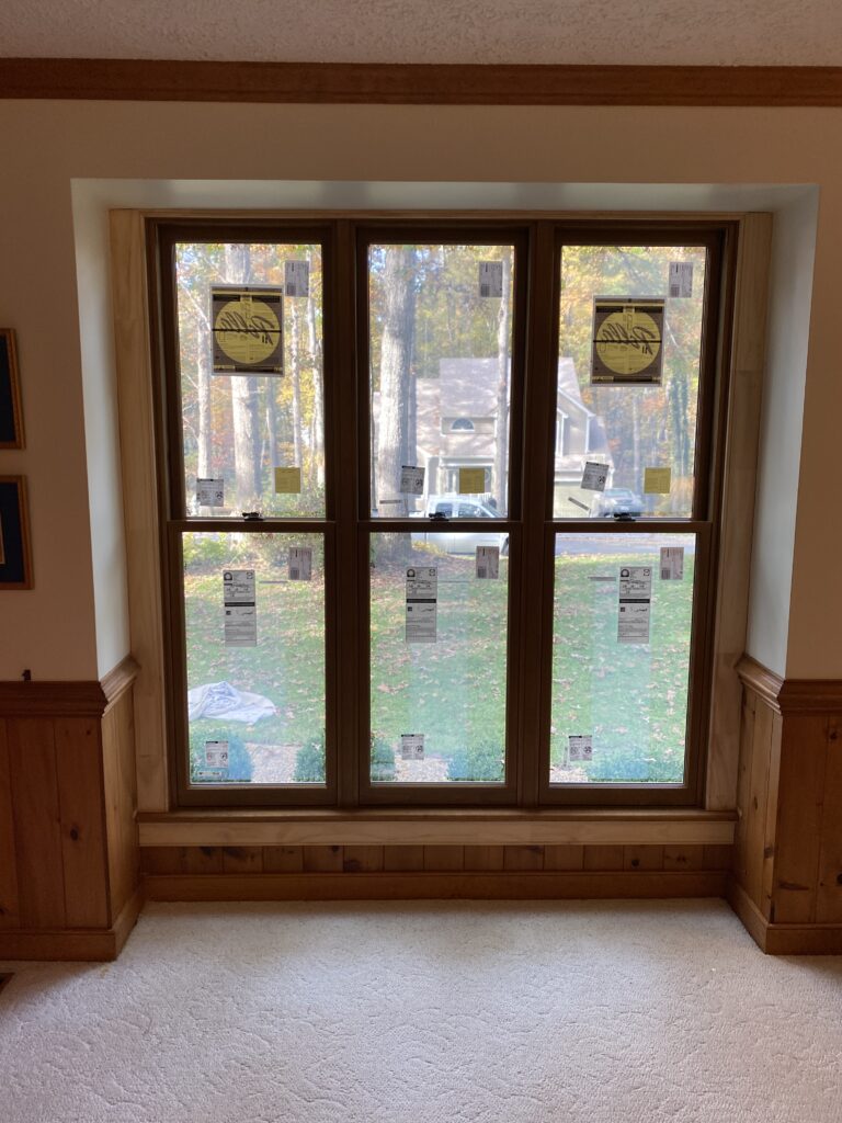 Large window overlooking a green outdoor scene.