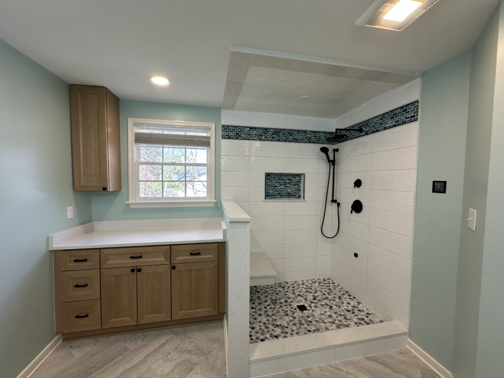 Modern bathroom with shower and wooden cabinets.