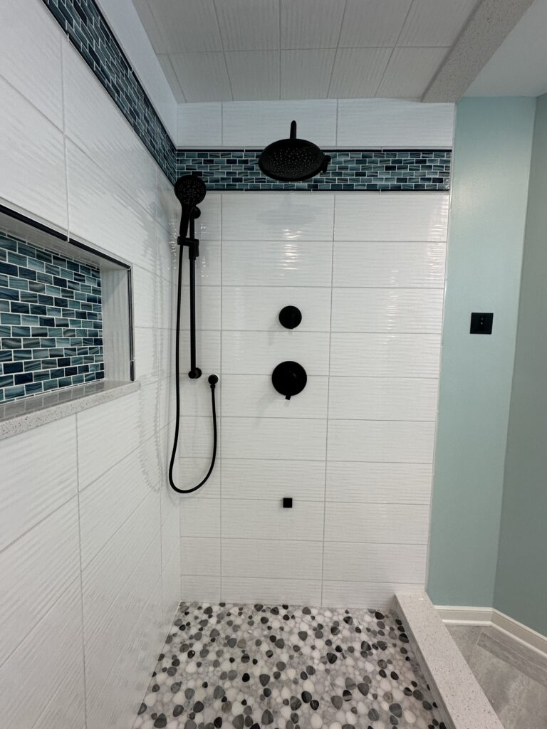 Modern shower with mosaic tile accents.