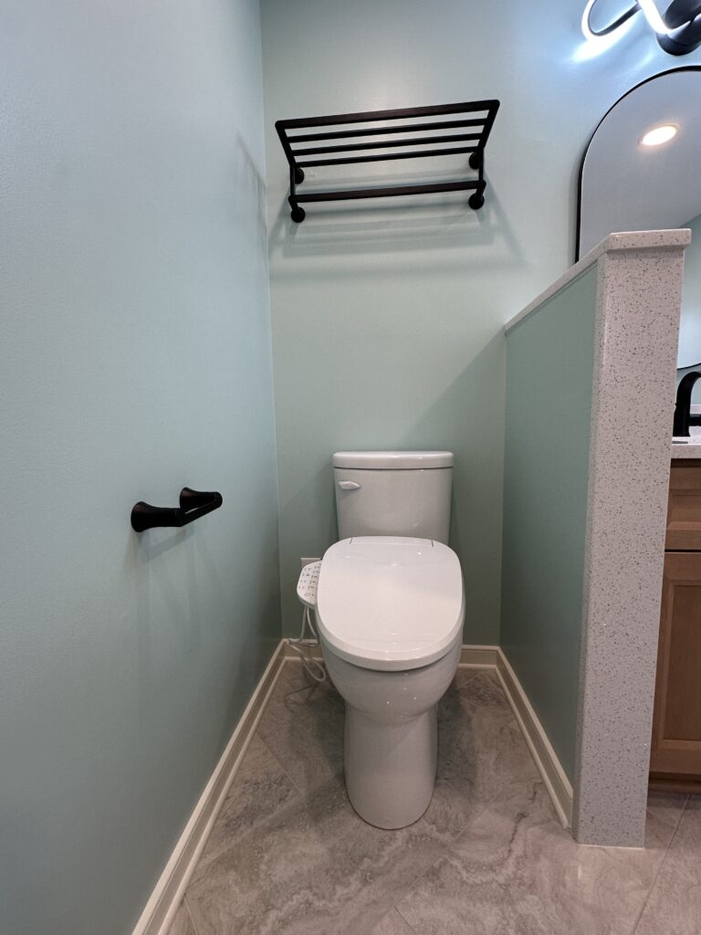 Bathroom with toilet and towel rack.