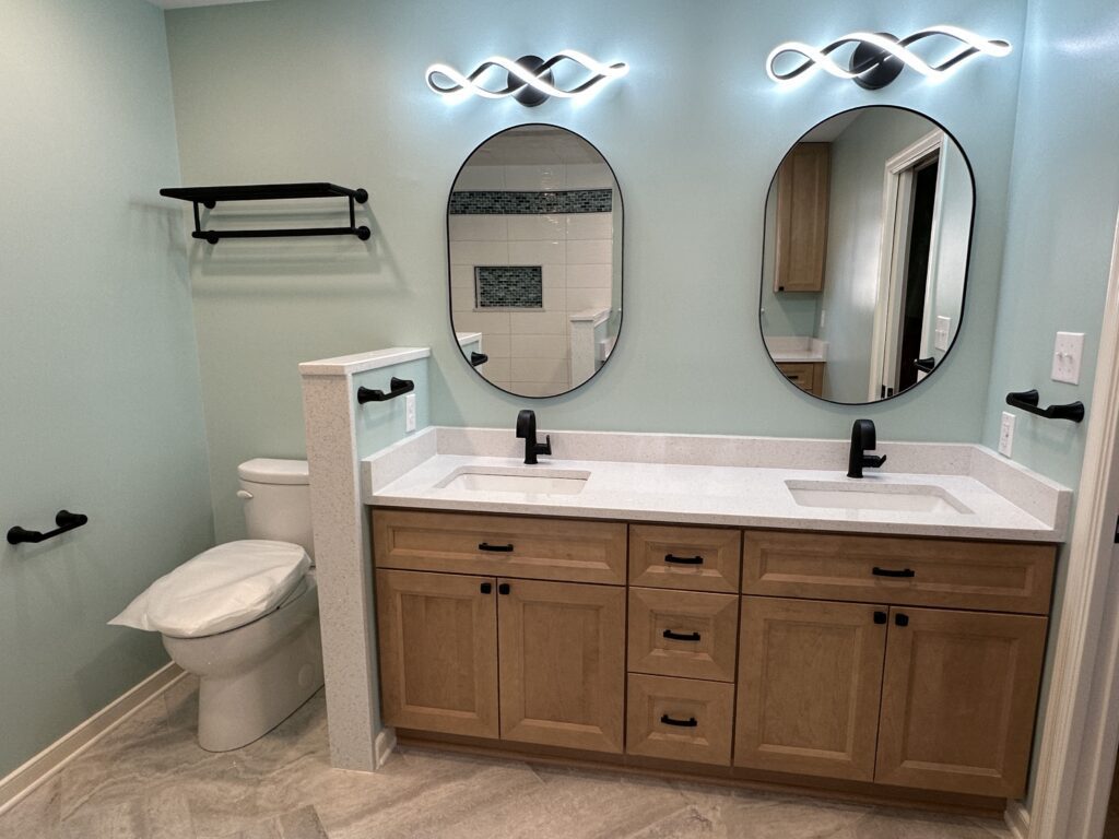 Modern bathroom with double vanity and mirrors.