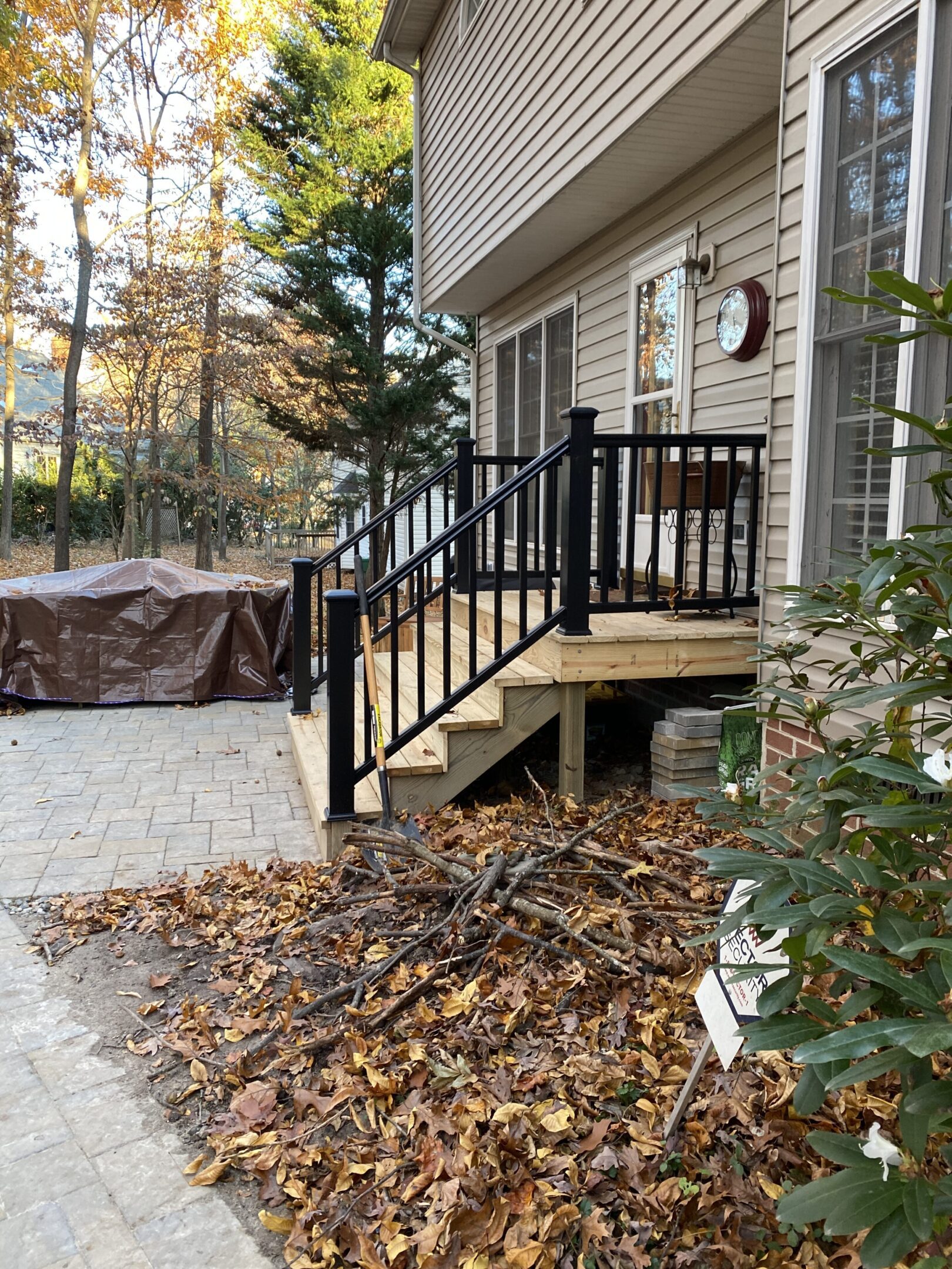 New wooden deck with black railings.