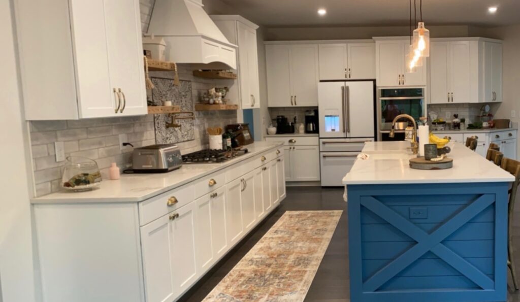 Modern kitchen with white cabinets and island.
