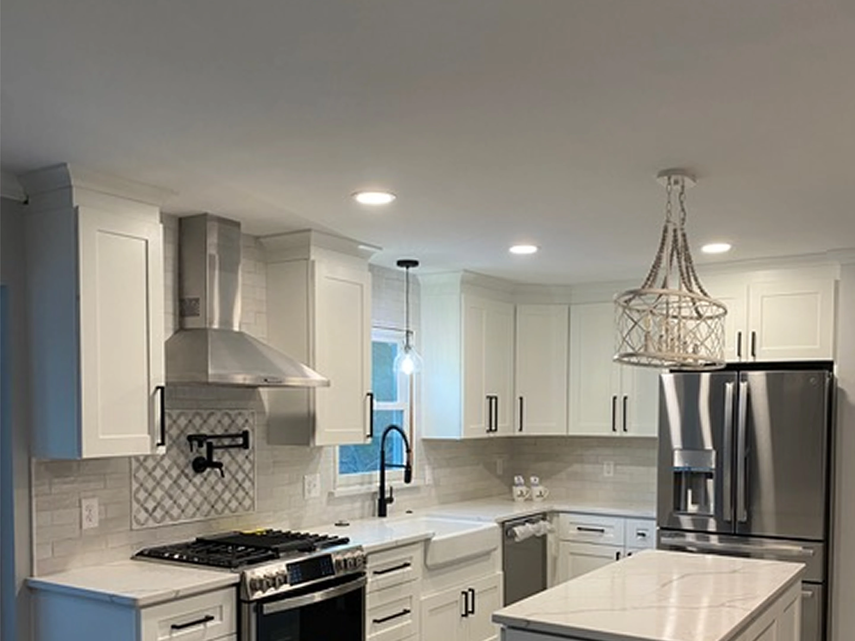 Kitchen ceiling with woven chandelier and hood