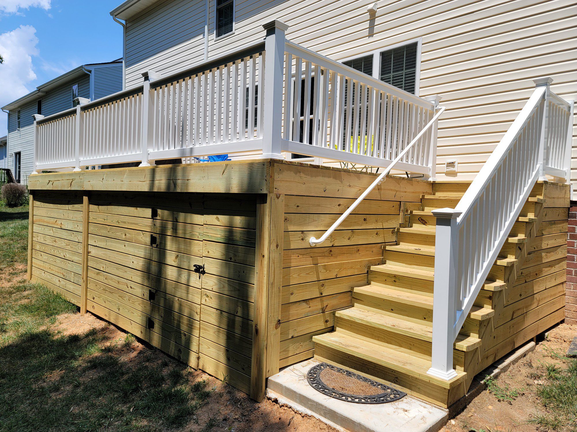 Elevated wood deck with white vinyl railing