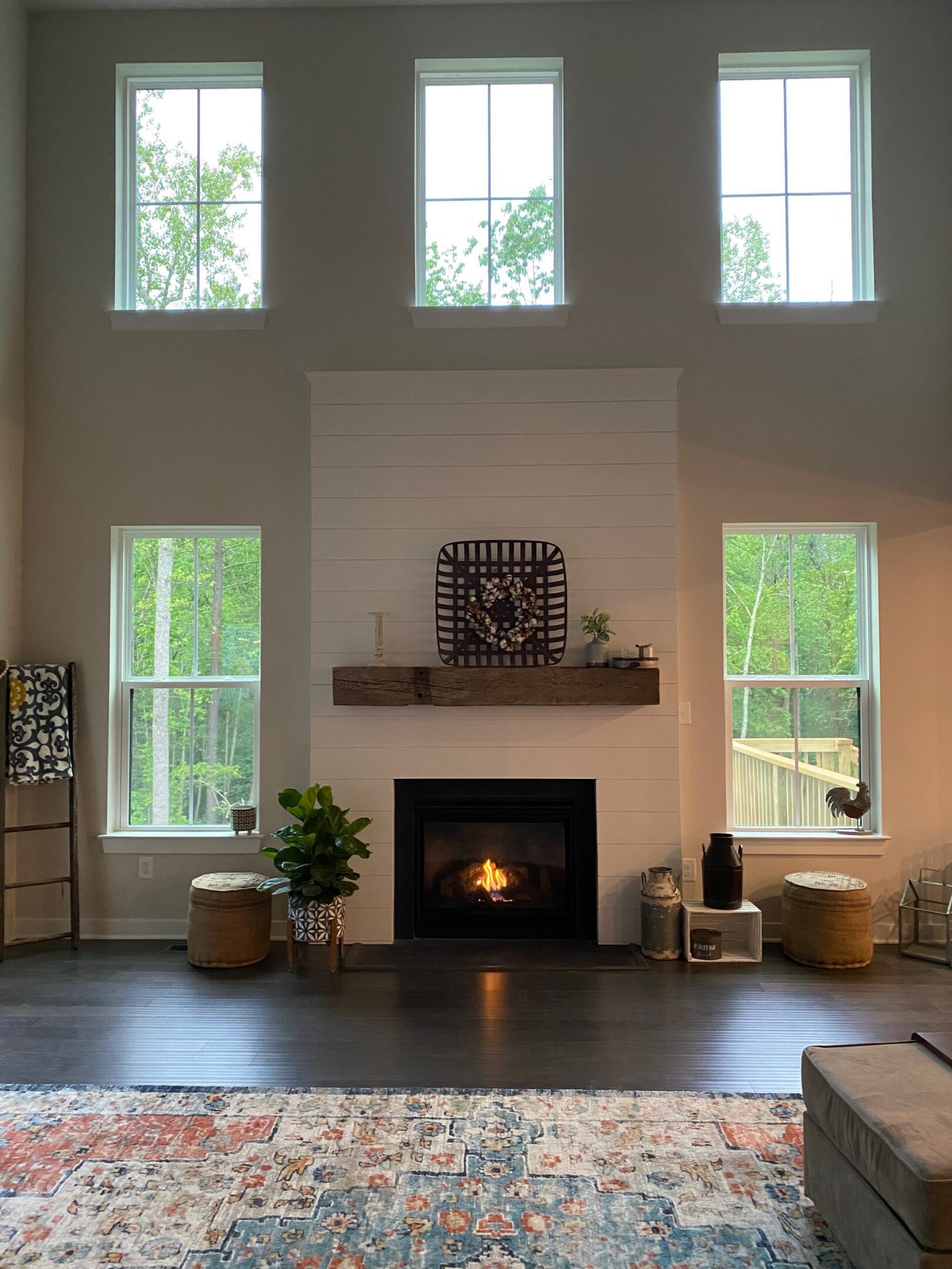 Cozy living room with fireplace and tall windows